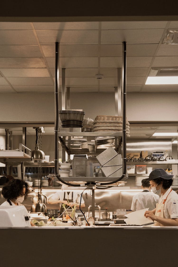 Workers In Restaurant Kitchen