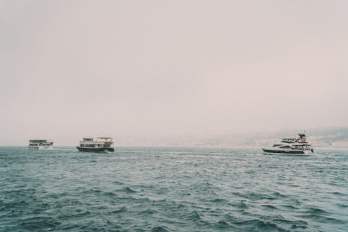 Yachts Sailing in Sea in Fog