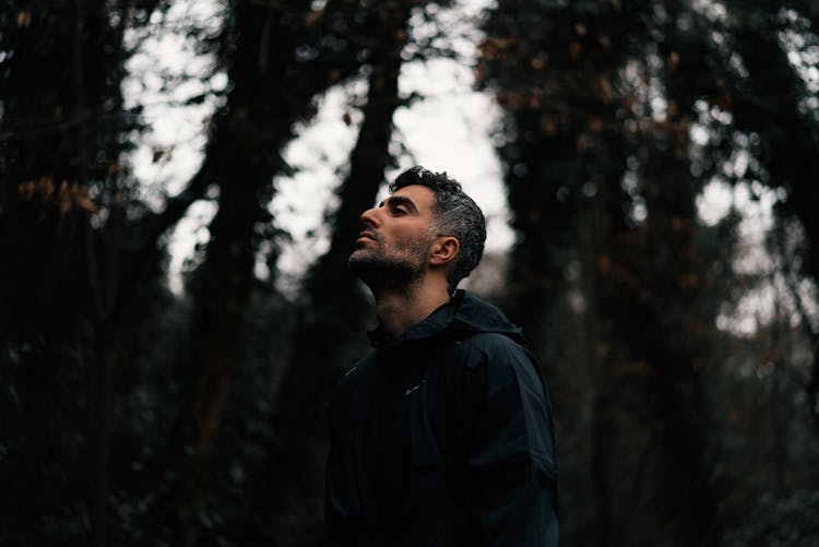 Man With A Stubble Standing In A Forest 