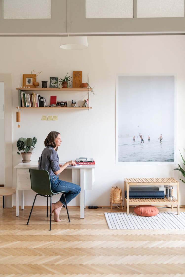 Woman Sitting At A Desk In A Modern Room At Home