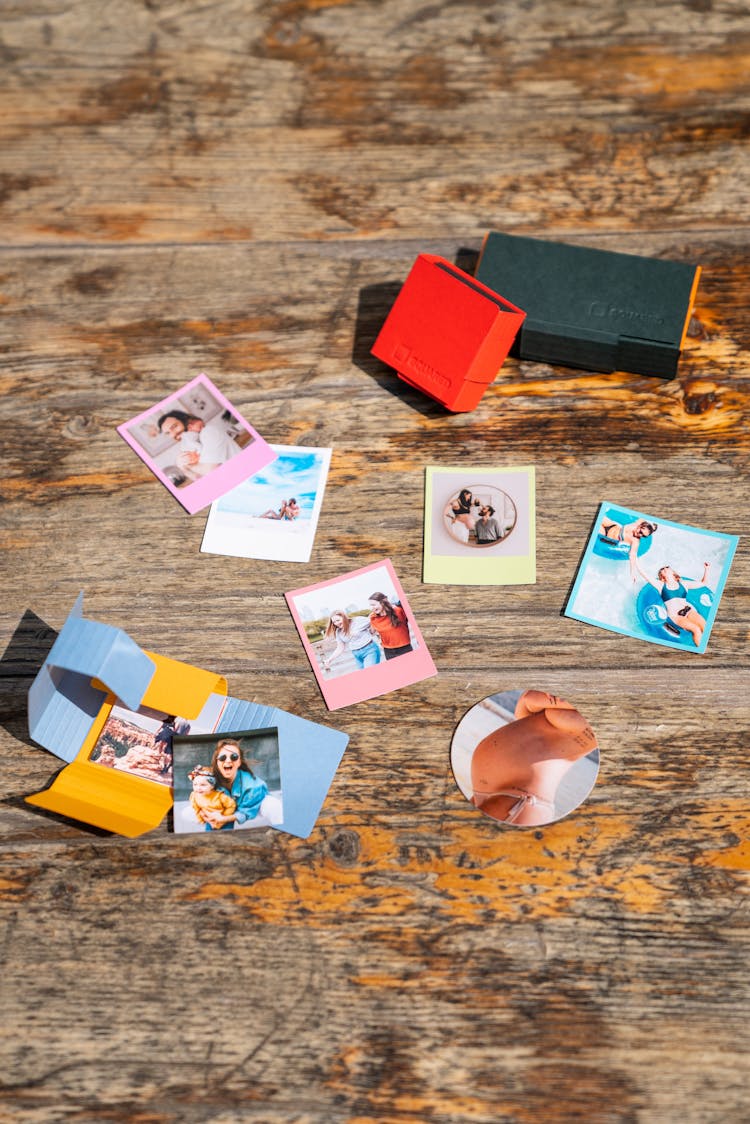 Photographs Scattered On A Desk 