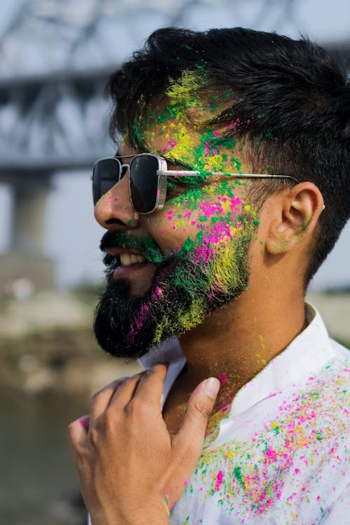 Smiling Man with Colorful Powder on Face