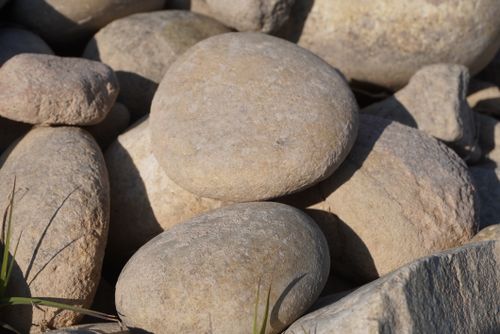 Free Close-up of smooth river stones basking in sunlight at Mangla Dam, Punjab. Stock Photo