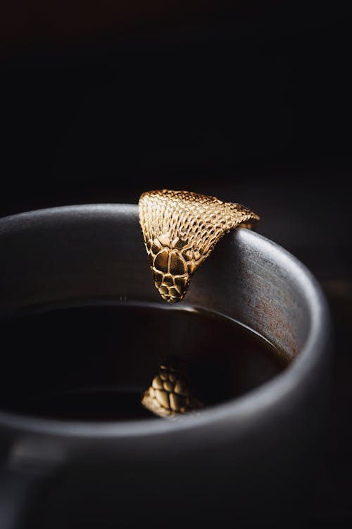 Golden Cobra Spoon over Coffee Cup