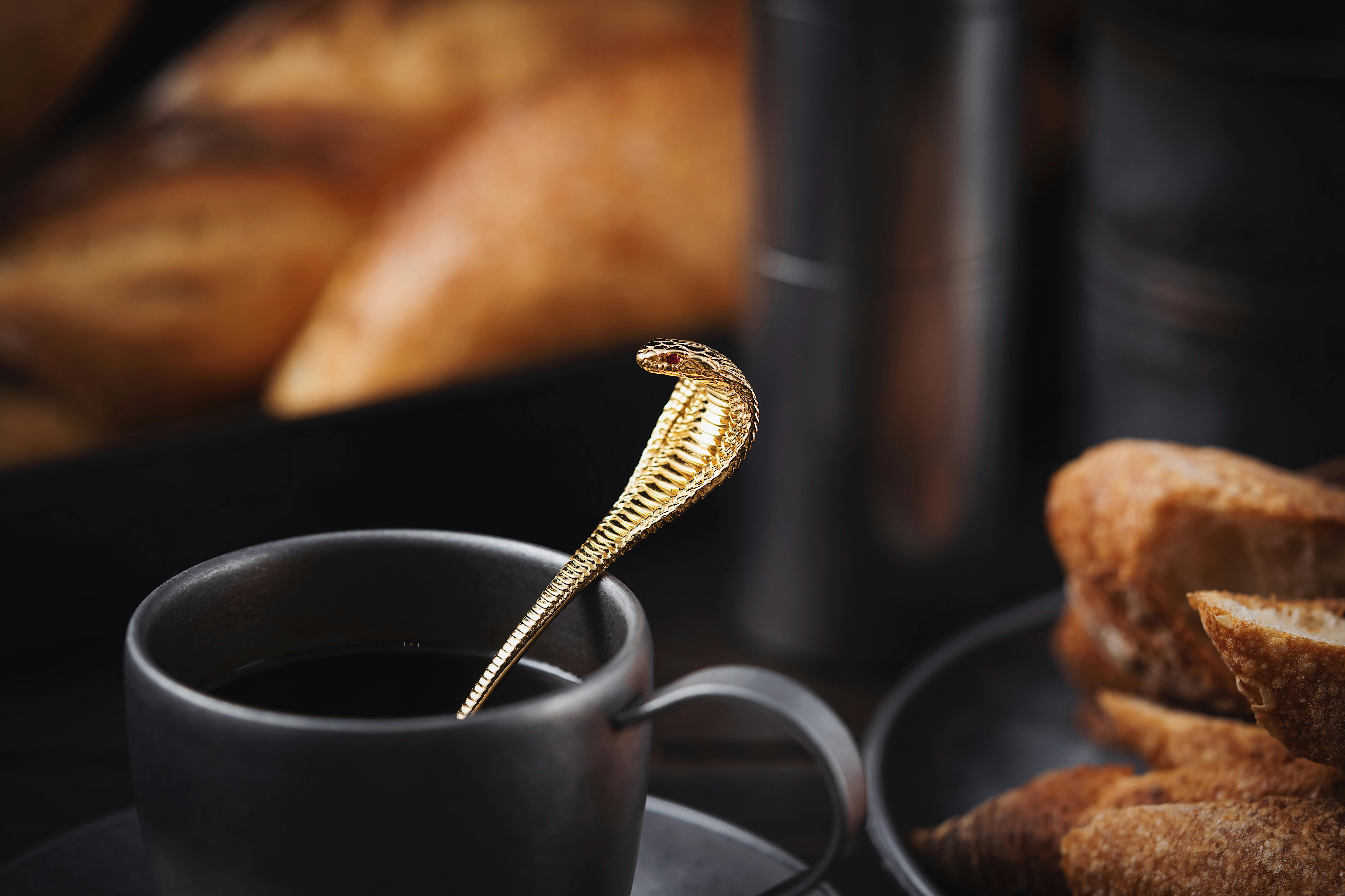 golden cobra spoon in cup