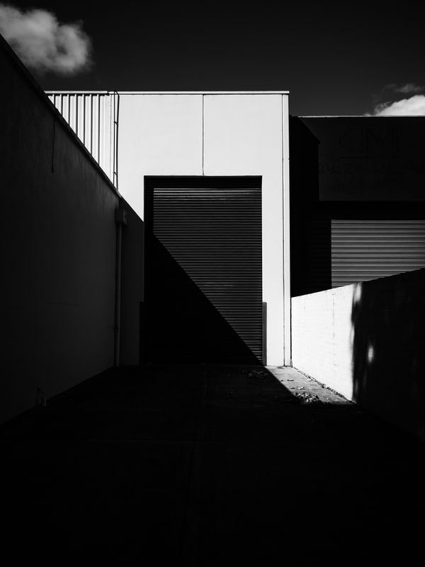 Shuttered doorway in deep shadow — Sonny Sixteen on Pexels