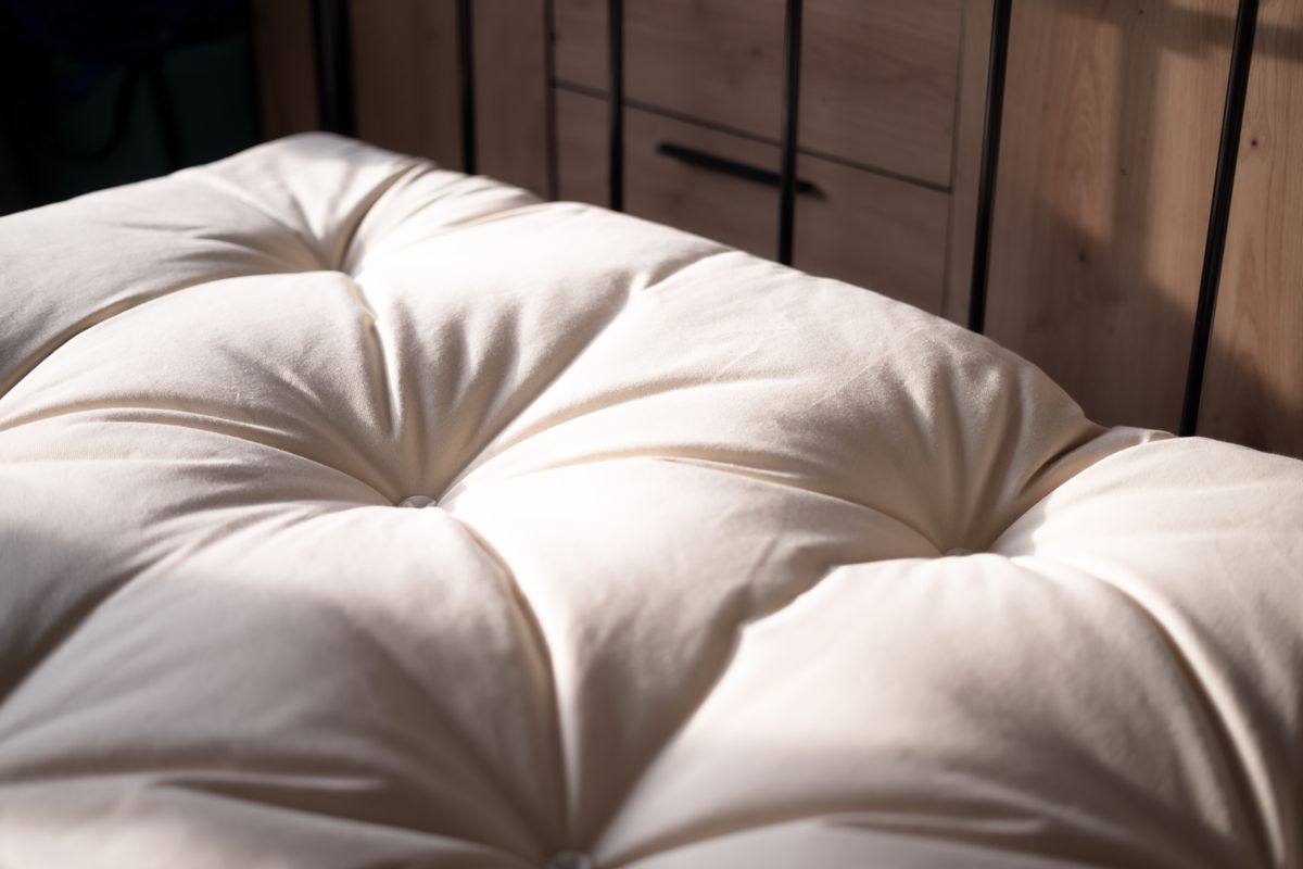 Close-up of a soft white sleeping pillow on a bed