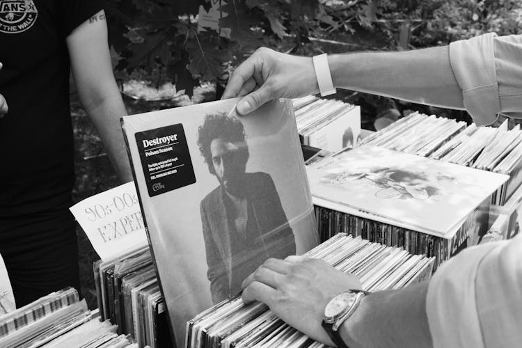 Close-up Of A Person Looking Through Vinyl Records 