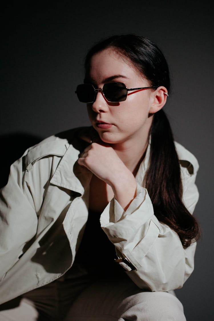 Woman In Sunglasses Posing In Studio