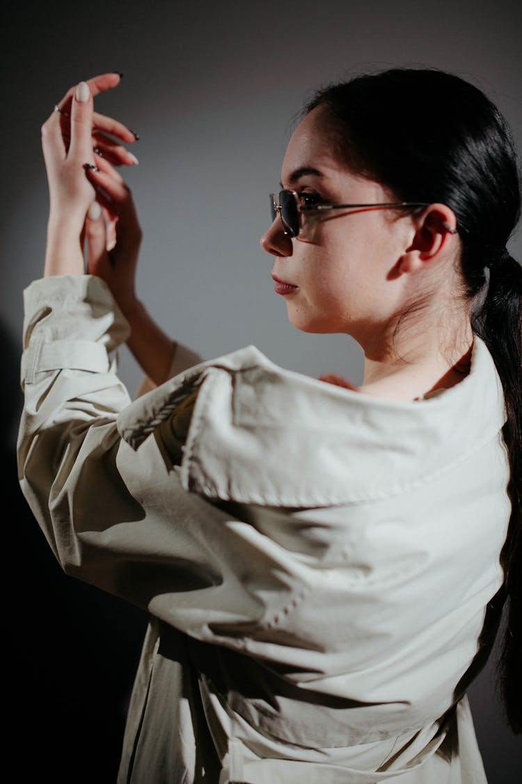 Woman In Sunglasses Posing In Studio