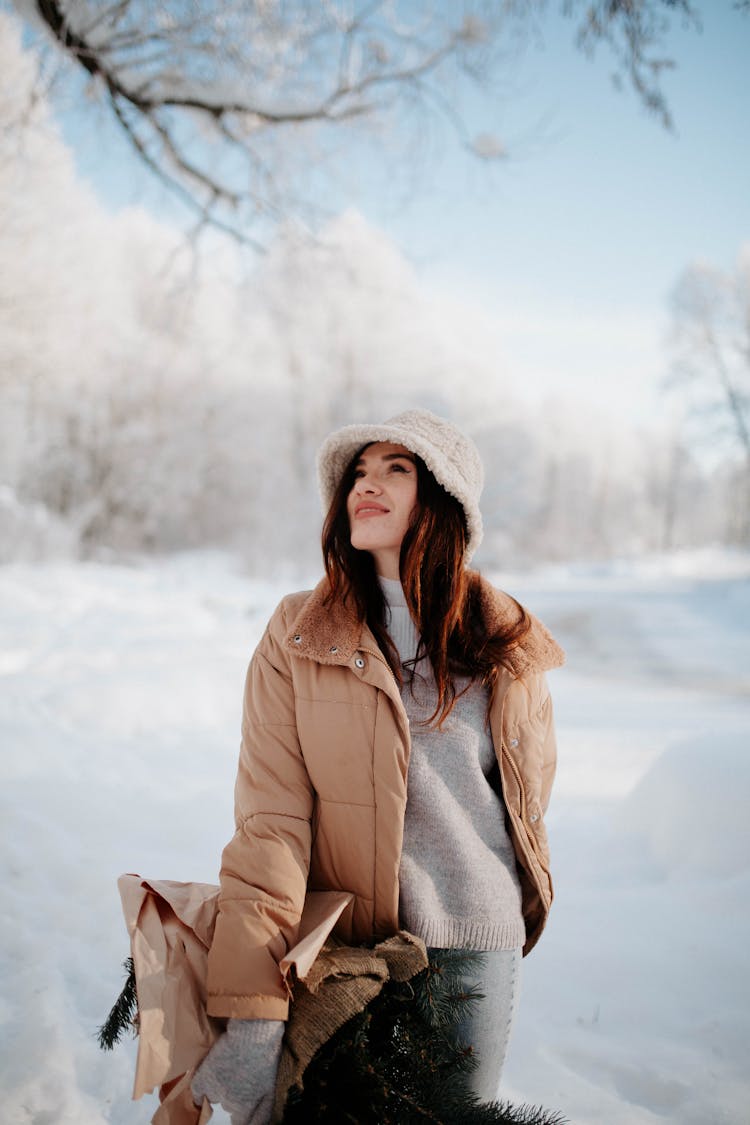 Woman In Outerwear Standing In Winter Forest