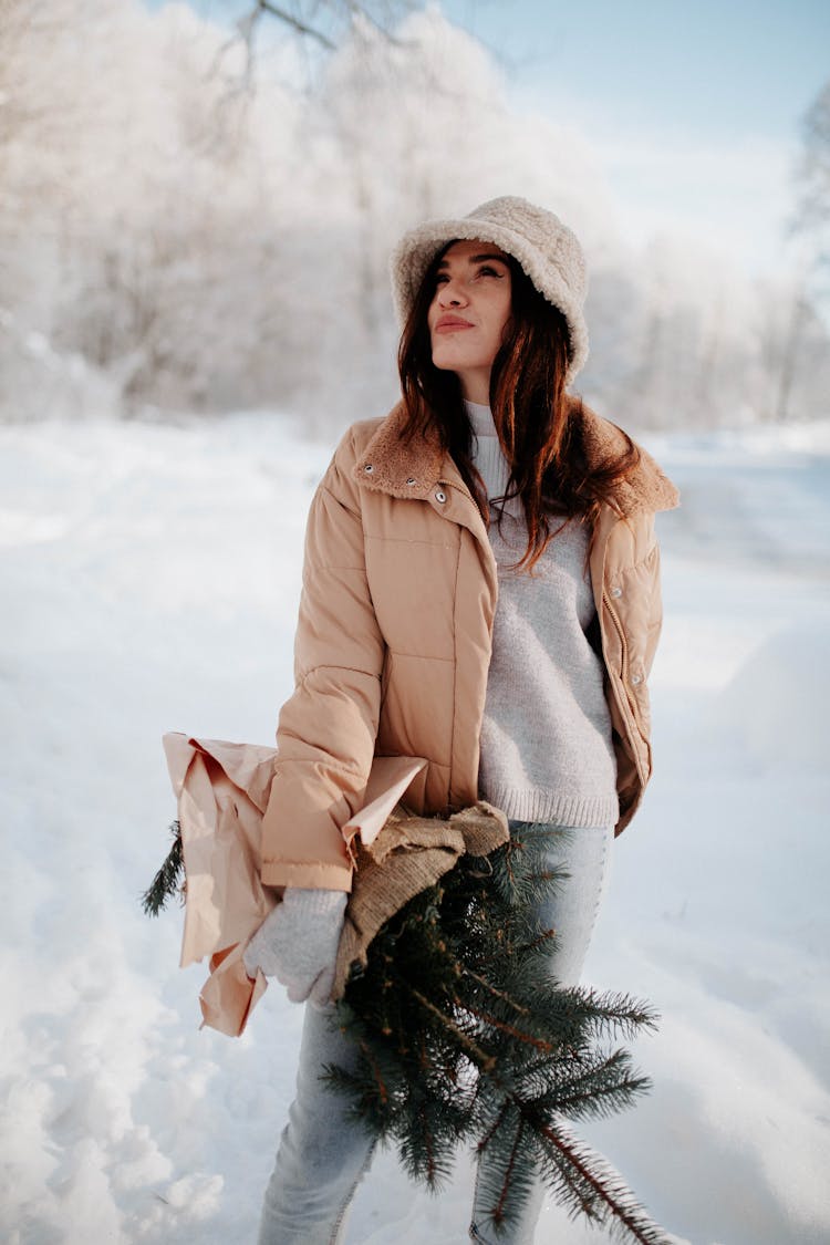 Smiling Woman With Spruce Branches In Winter Forest