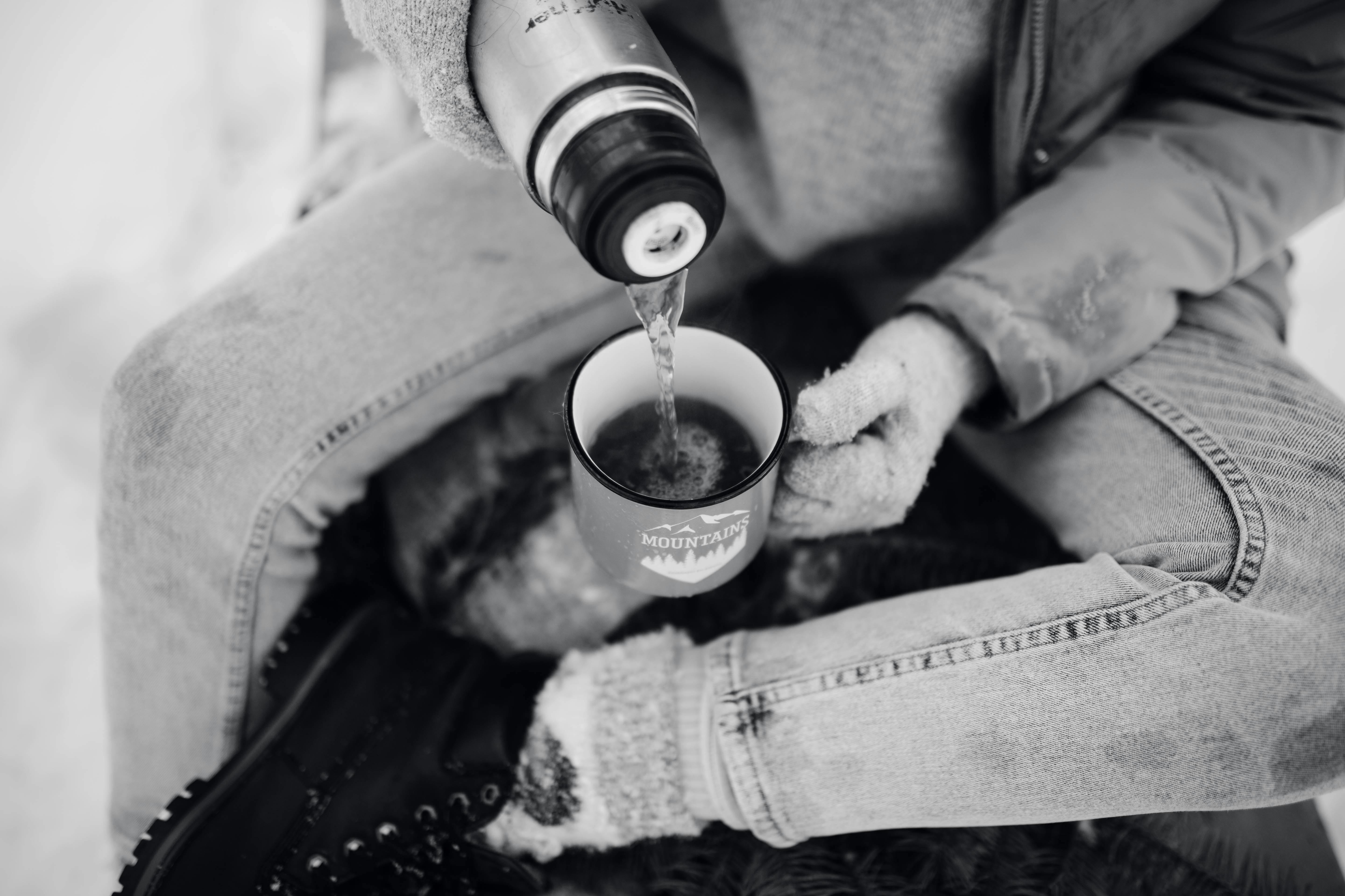 Close-up view of pouring hot tea from thermos into cup Stock Photo