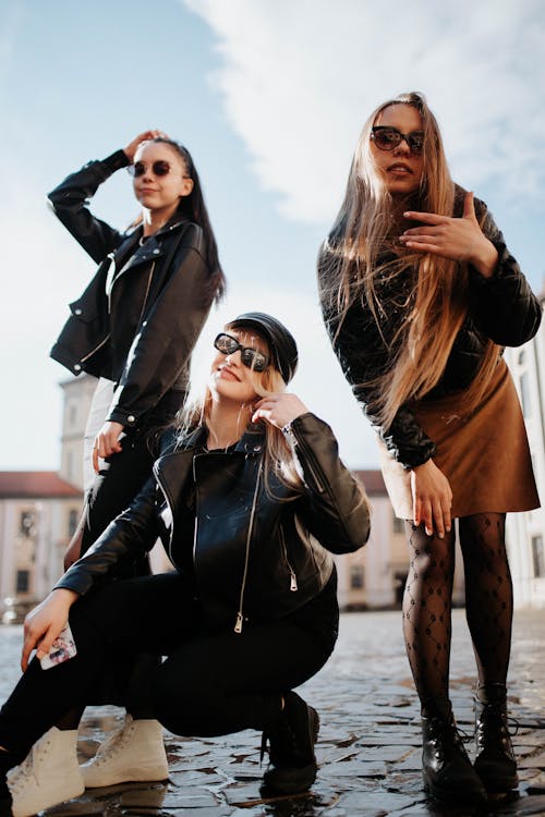 Three Women with Long Hair and Wearing Black Jackets, Posing on a ...