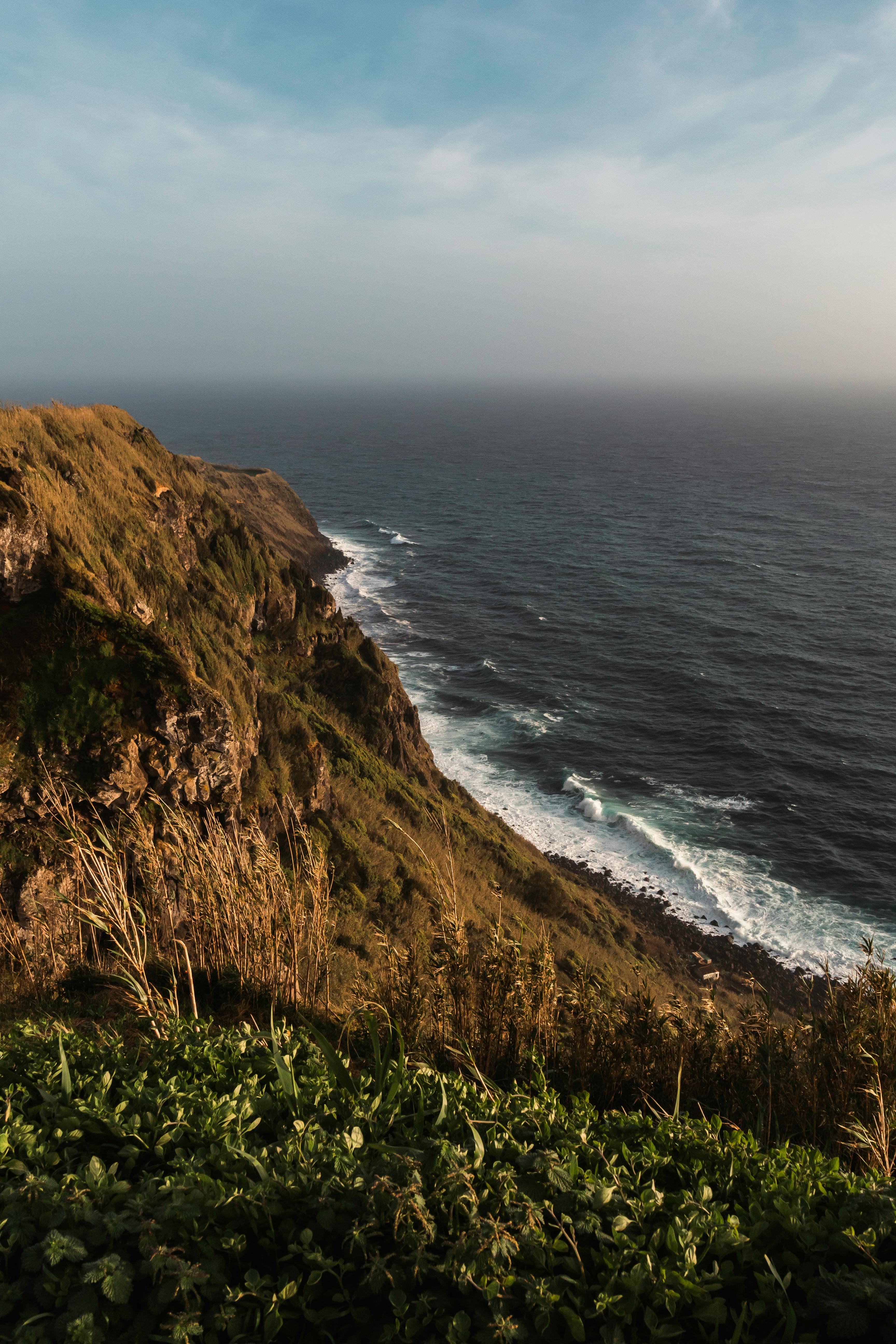 Breathtaking view of a rugged cliff along the coastline in Ponta Delgada, Azores, Portugal.