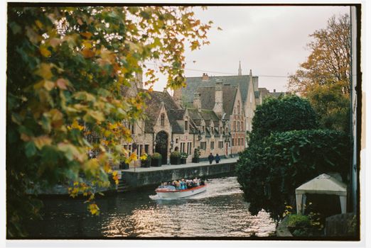 Pre-dawn canal row with a photographer — Bruges