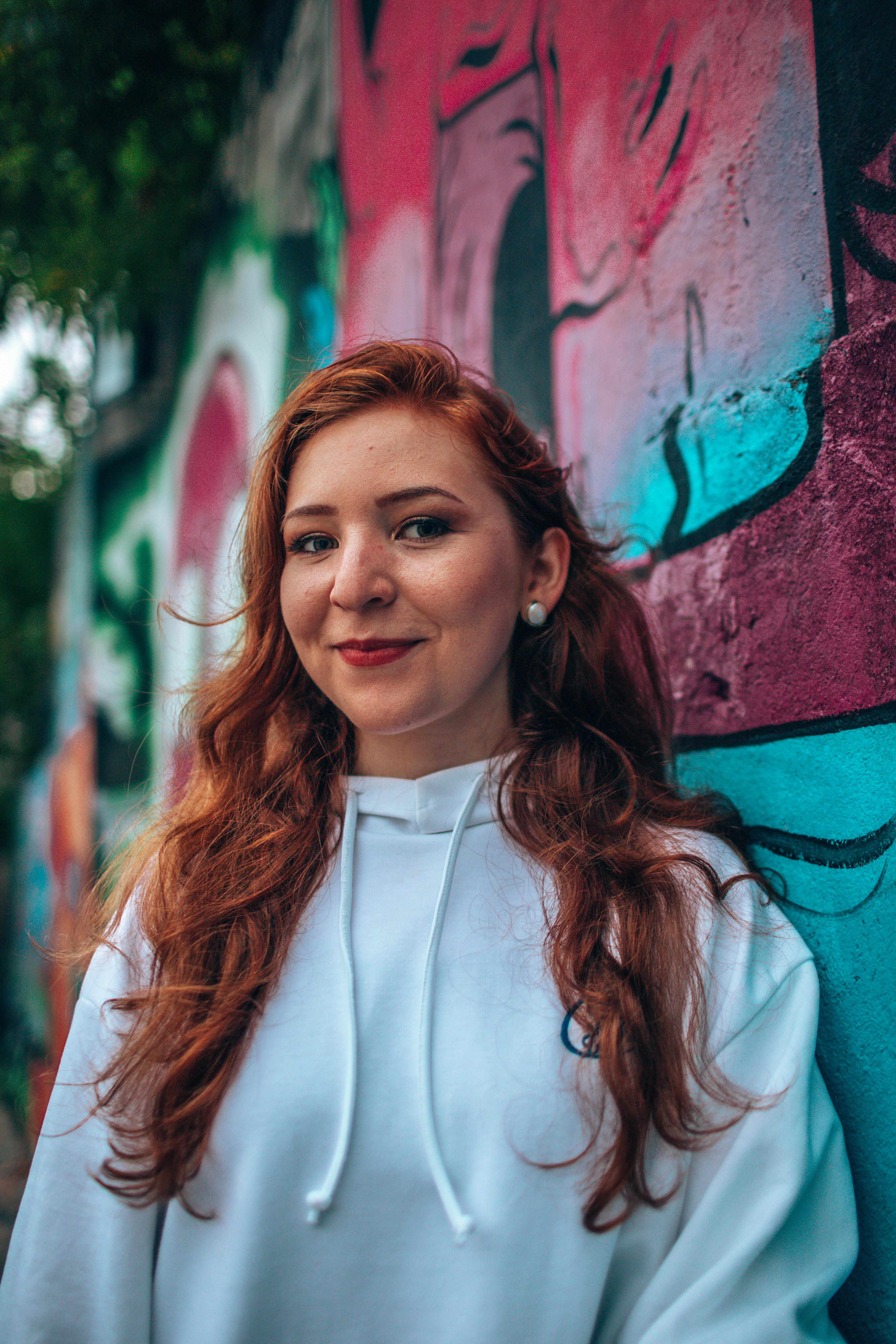 Woman Leaning on Teal and Red Wall