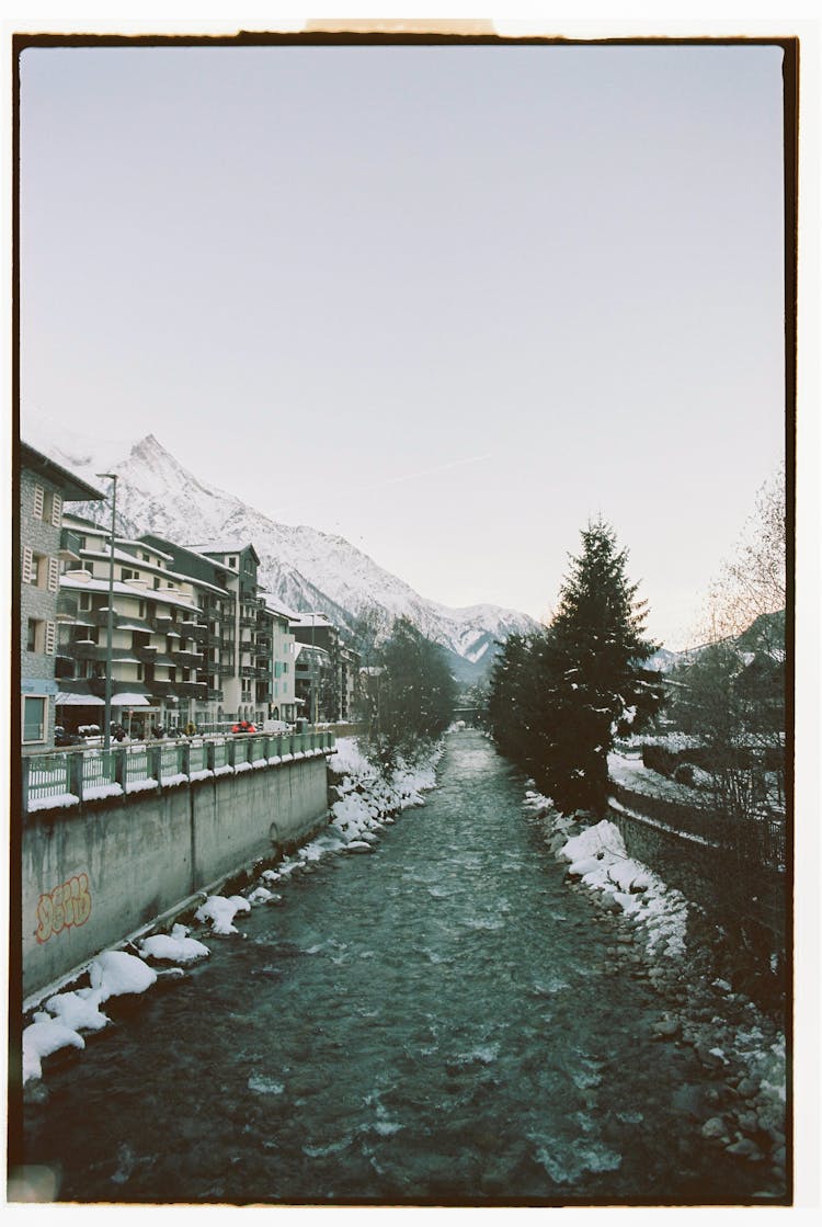 River In Town In Mountains Landscape