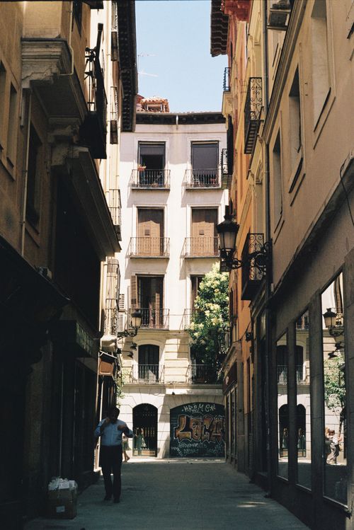 Free A picturesque street in Madrid with historic architecture and vibrant urban life. Stock Photo