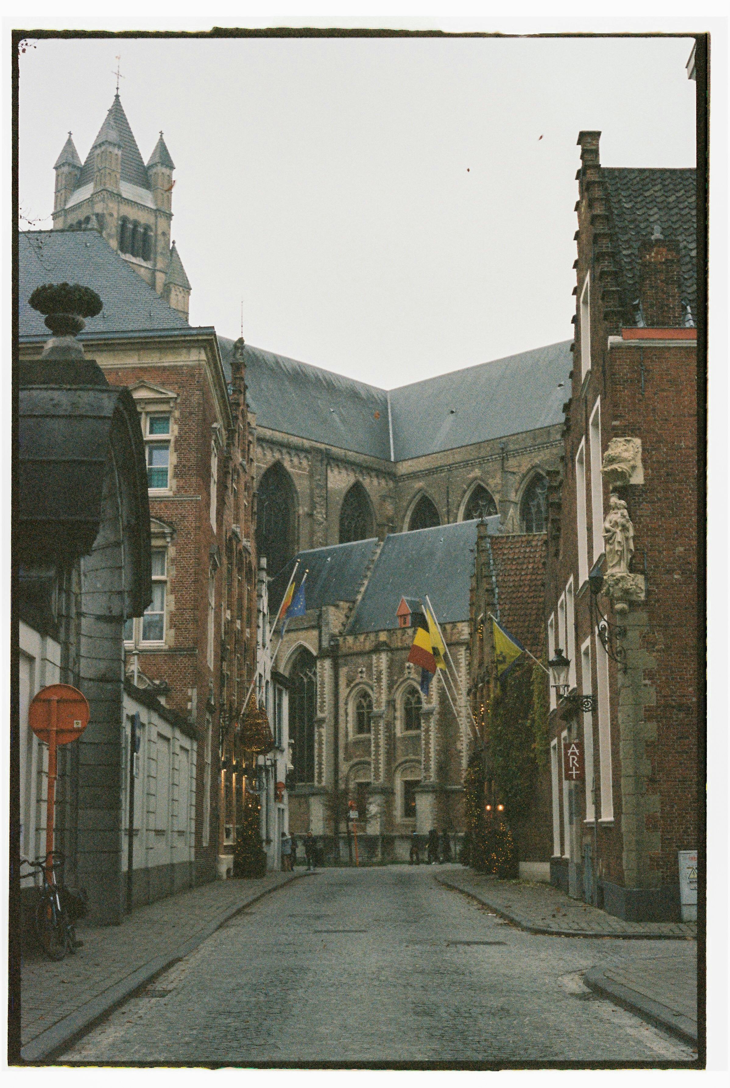 Explore a charming street scene featuring gothic architecture in Bruges, Belgium.
