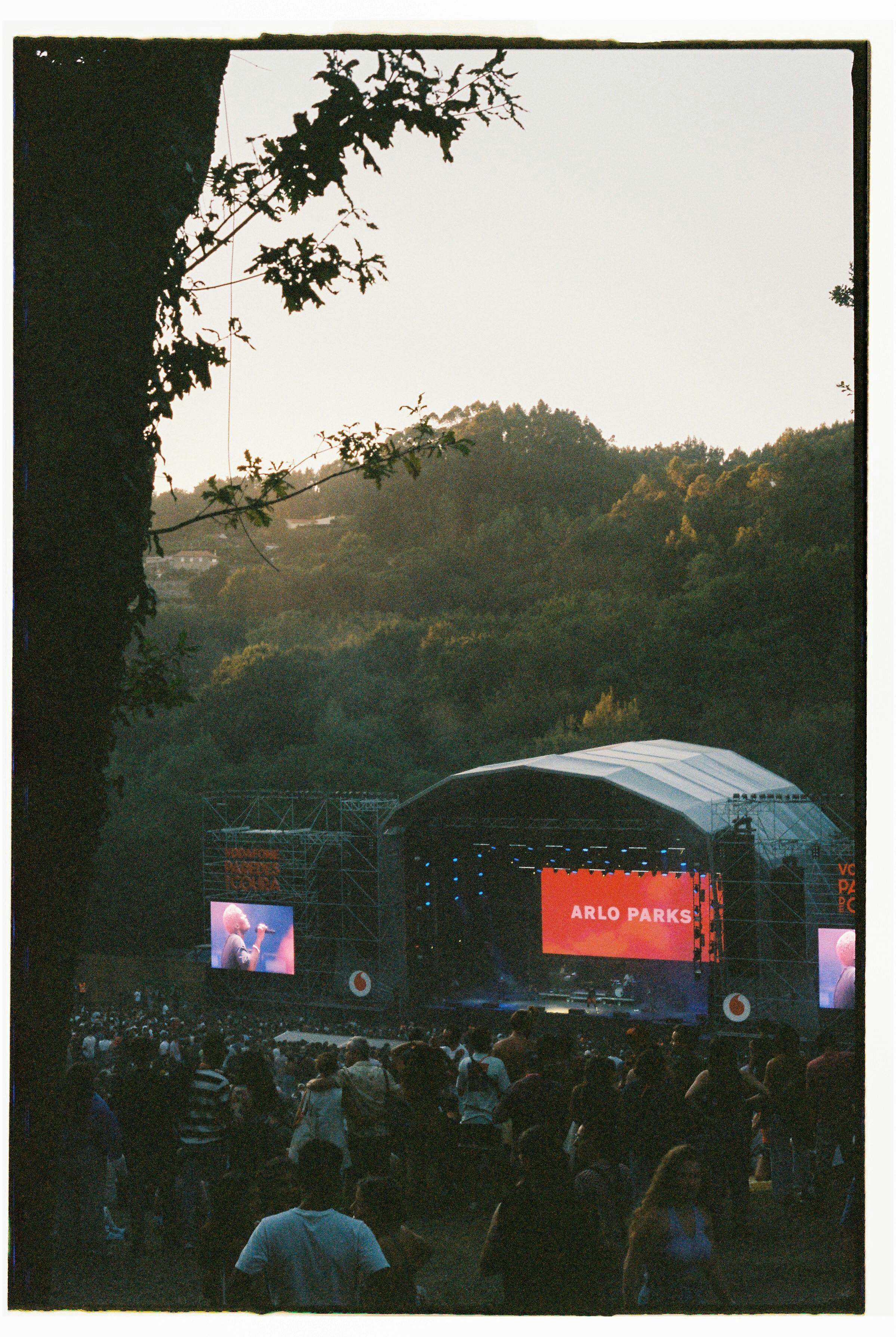 Outdoor music concert at sunset in Coura, Portugal with crowd enjoying a live performance.