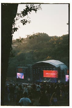 Outdoor music concert at sunset in Coura, Portugal with crowd enjoying a live performance.