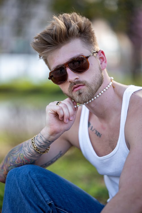 Man Posing with Sunglasses and Tattoo