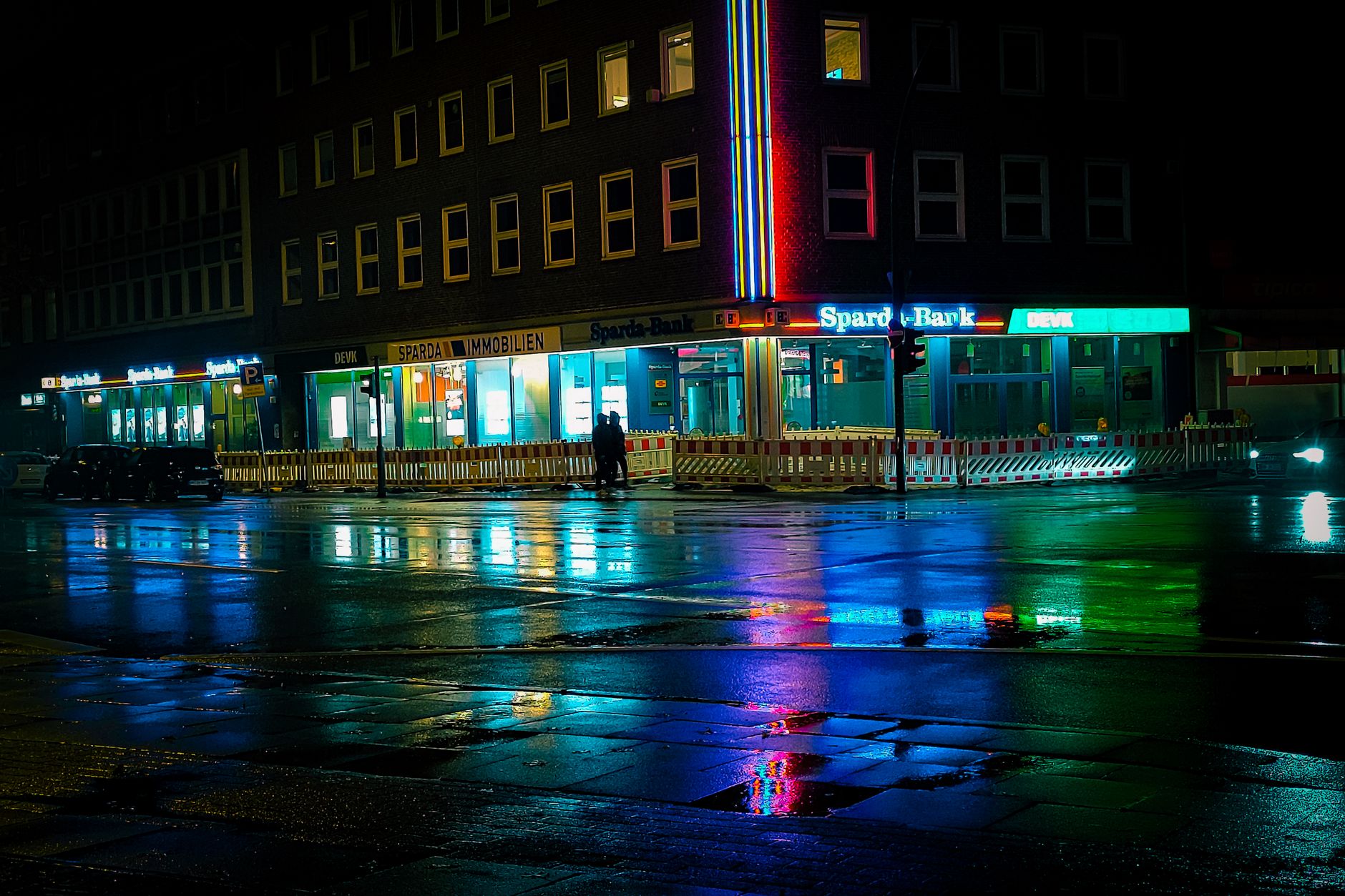 Colorful reflections on wet streets at night in a city with neon lights and building signage.. colorful, reflections, streets