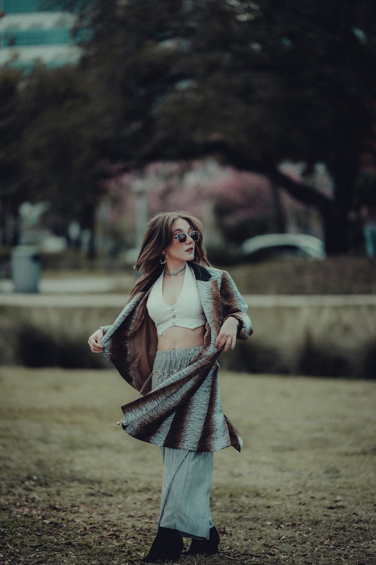 Woman Posing In A Park Dressed In A Coat