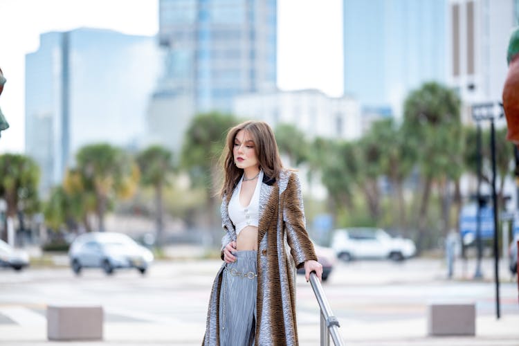 Woman In A Coat Holding Onto A Handrail