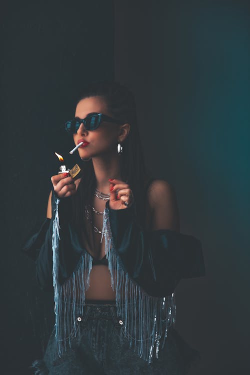 Woman in Sunglasses Lighting Cigarette