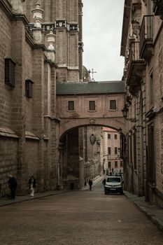 A serene street scene showcasing the historic stone architecture of Toledo, Spain.