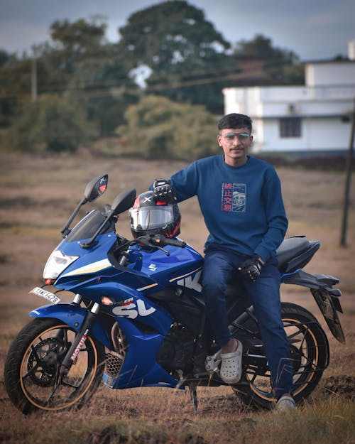 Photo of a Young Man Sitting on His Motorcycle