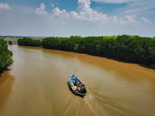 Group of People Riding Boat in Middle of River