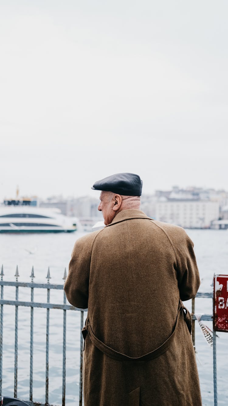 Man In A Woollen Coat Standing At The Sea