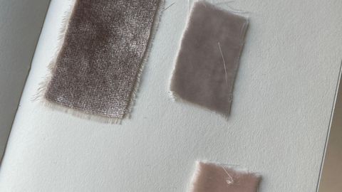 Close-up of fabric swatches on a notebook, showcasing texture and minimalist design.