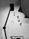 Black and White Picture of a Lamp and Wall with Pictures and Drawings