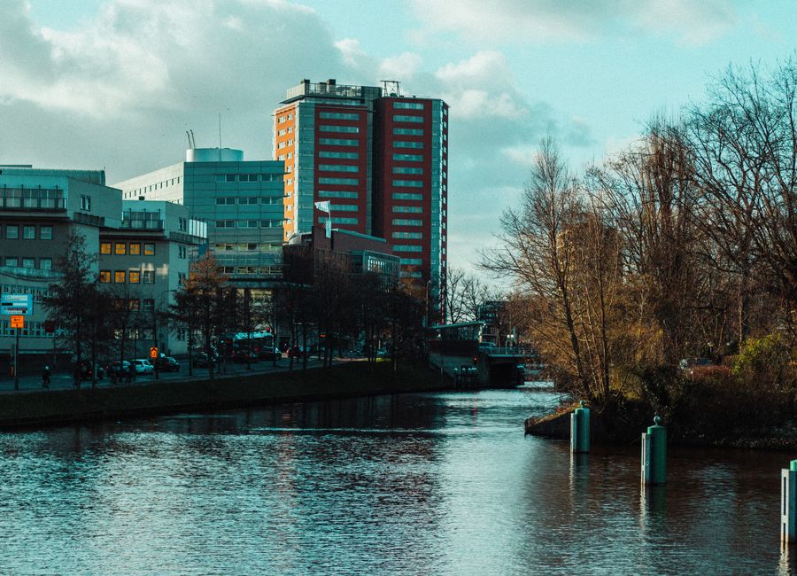 Explore the modern architecture along Groningen's scenic canal during a crisp fall day.