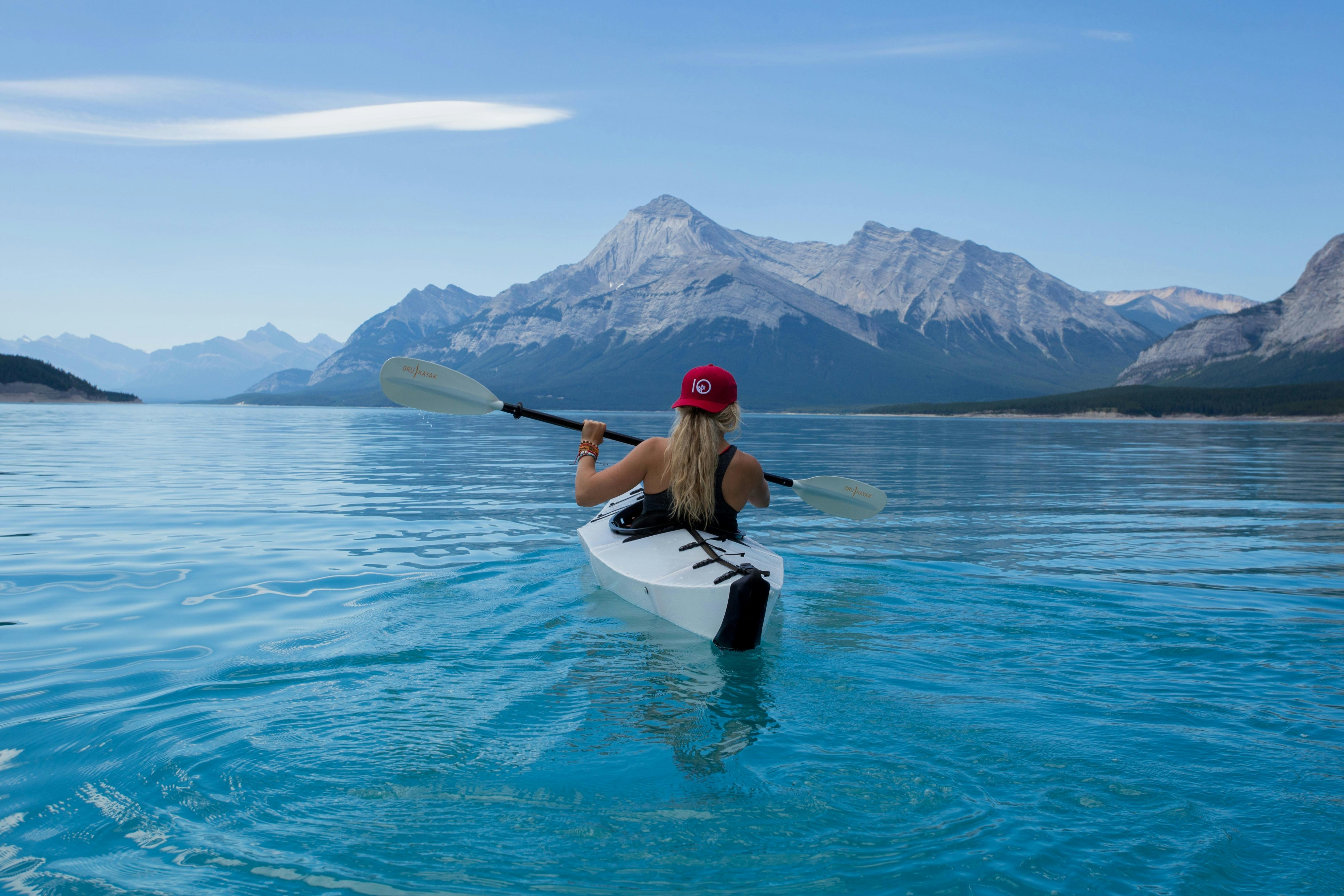 woman on white kayak free stock photo