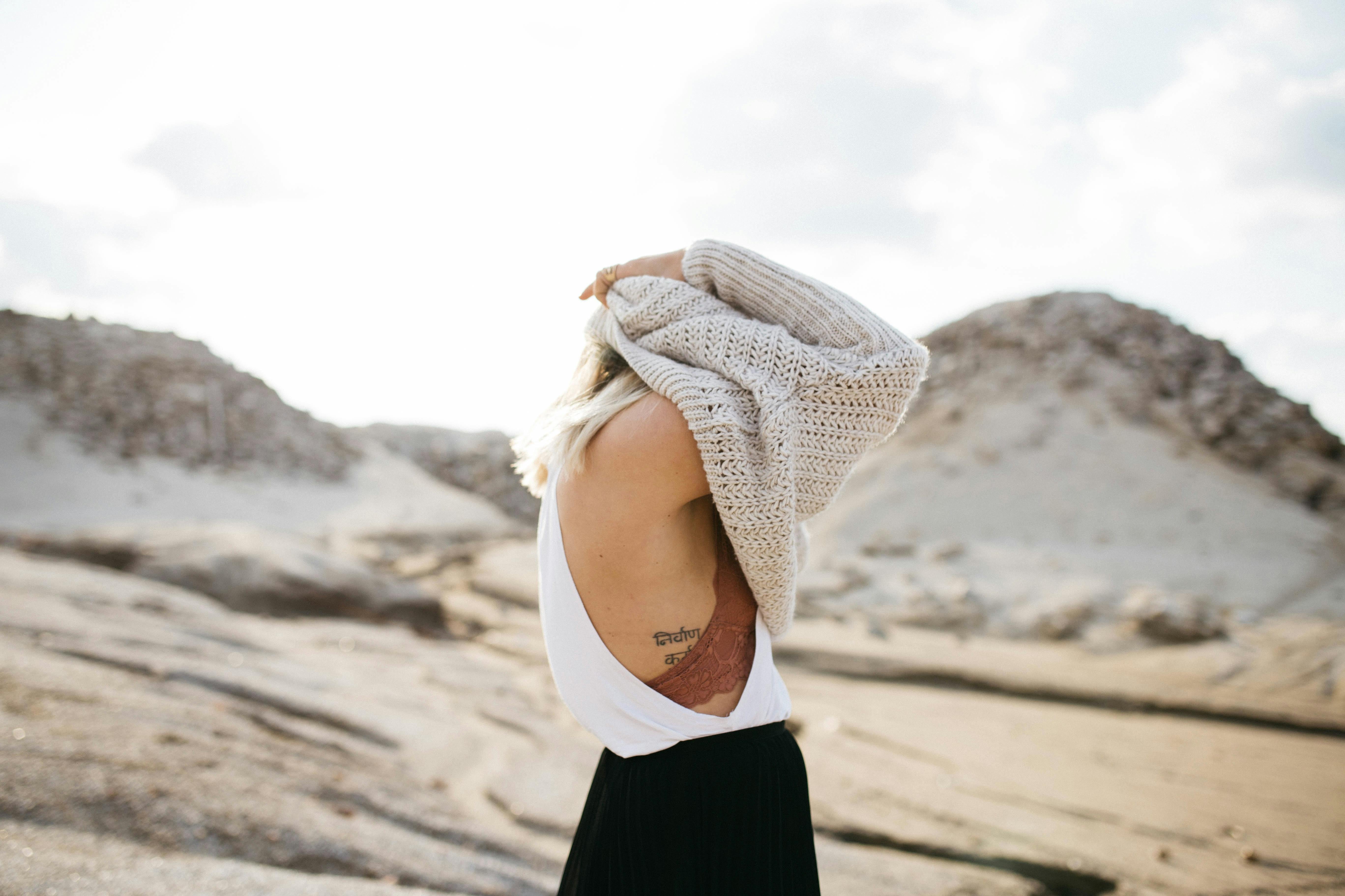 Women Taking Off Knitted Sweater · Free Stock Photo