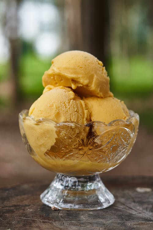 Three Scoops of Yellow Ice Cream in a Glass Cup 