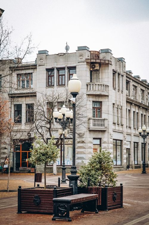 Free Charming urban scene with historic buildings and streetlamps on a quiet city street. Stock Photo