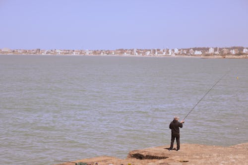 View of a Man Fishing from a Shore 