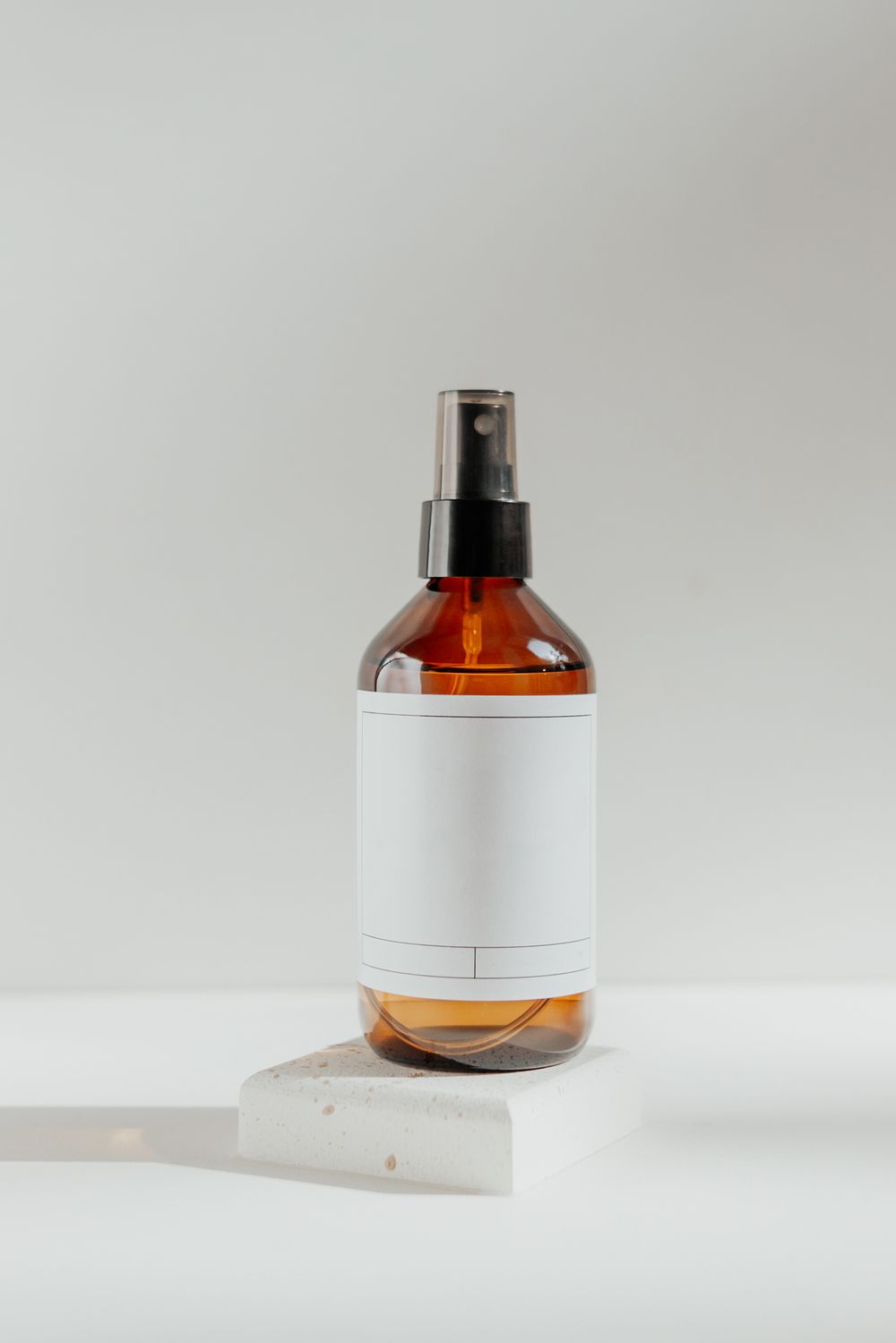 Amber texture spray bottle with a blank label