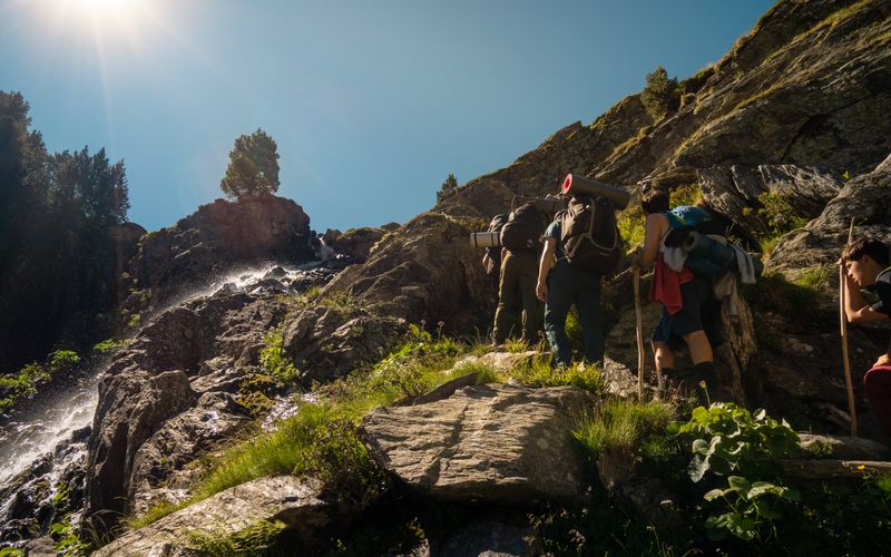 Hikers with backpacks on a mountain trail