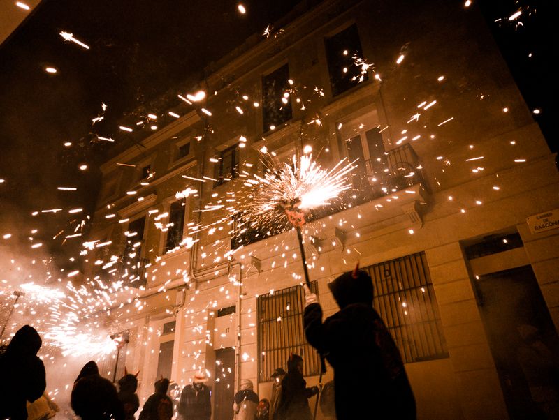Vibrant street celebration in Barcelona with crowds gathered under decorations