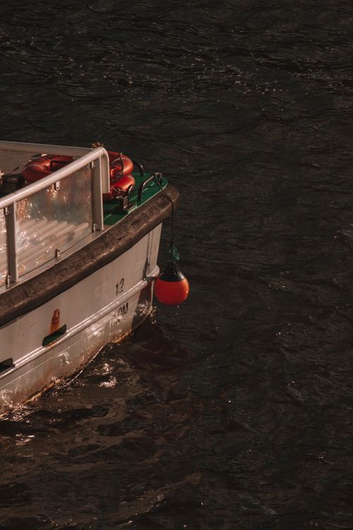 Free A detailed view of a moored boat on dark waters in Dublin, Ireland. Ideal for maritime themes. Stock Photo