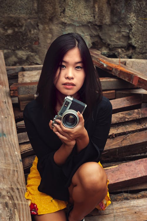 Woman Sitting with Camera