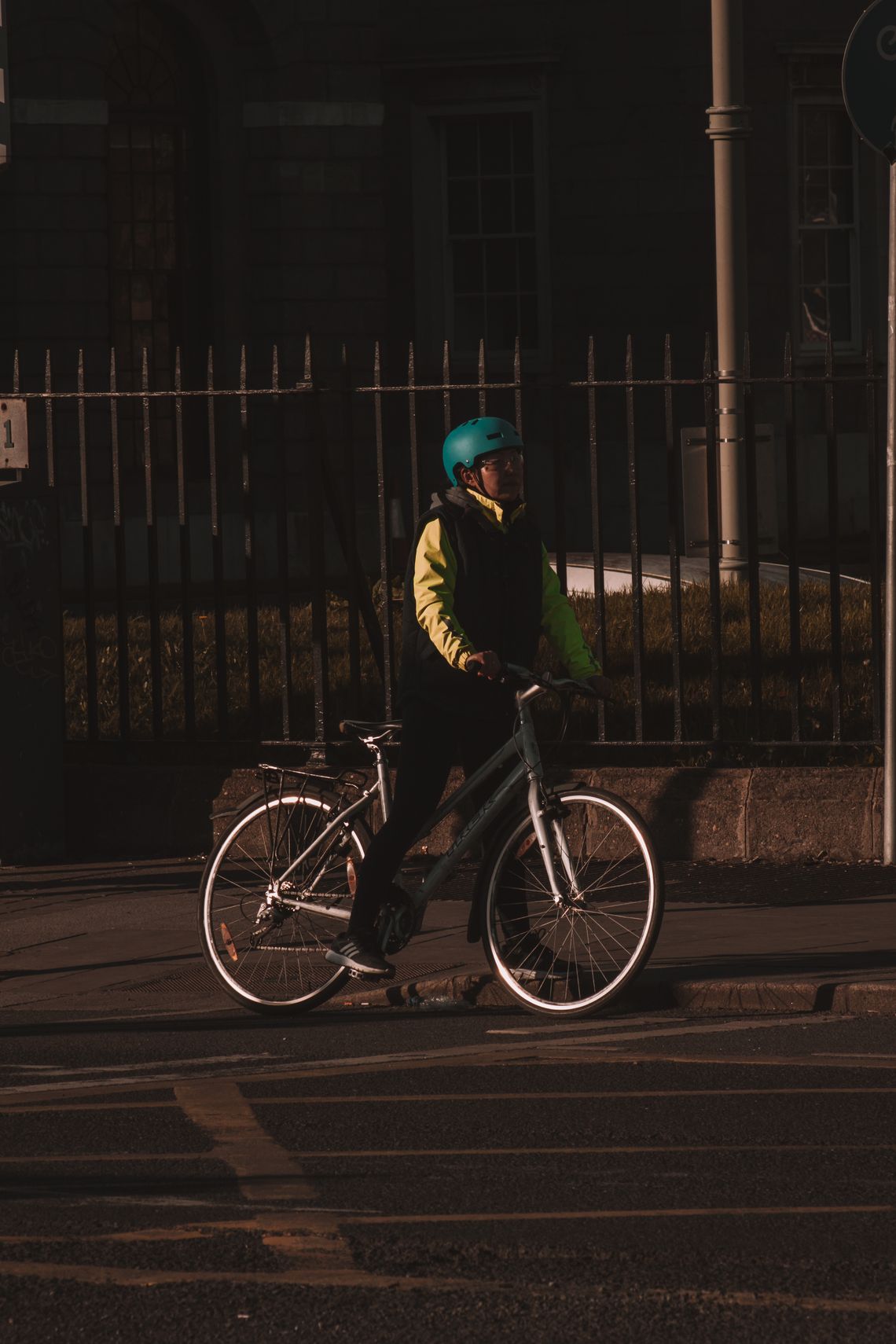 Cyclist wearing a helmet on an urban street in evening light