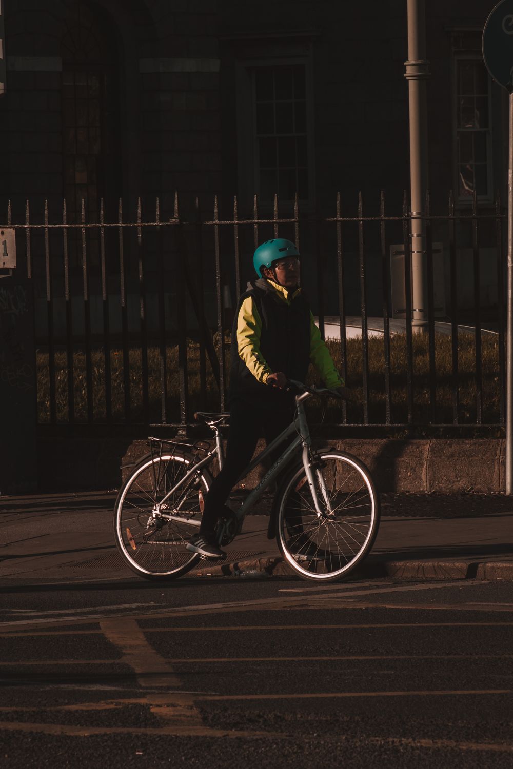 Urban cyclist wearing a helmet while riding through a city street